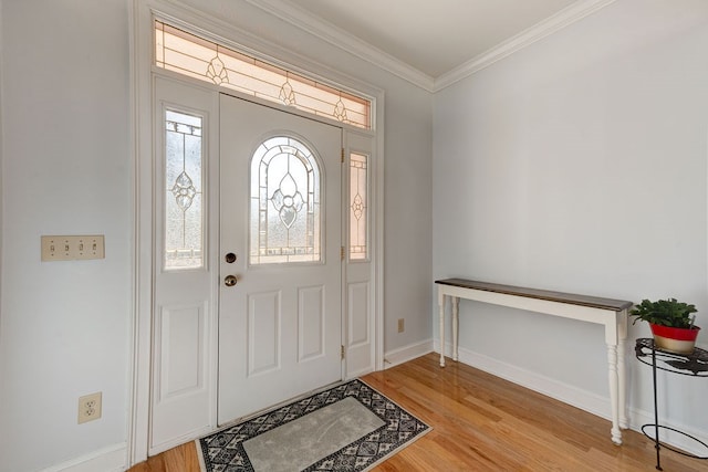 foyer entrance featuring ornamental molding and light hardwood / wood-style flooring