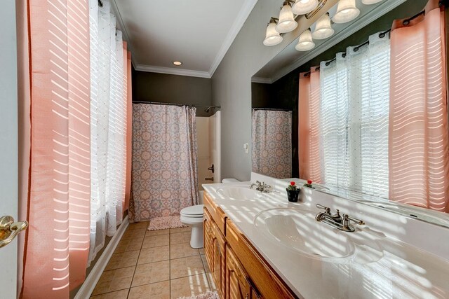 full bathroom with shower / tub combo with curtain, vanity, ornamental molding, tile patterned floors, and toilet