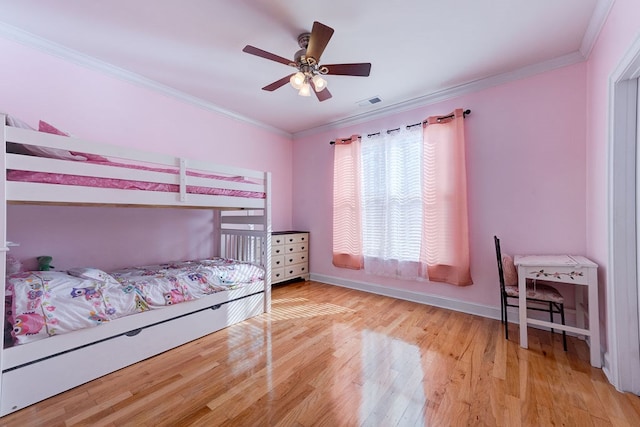 bedroom with crown molding, light hardwood / wood-style flooring, and ceiling fan