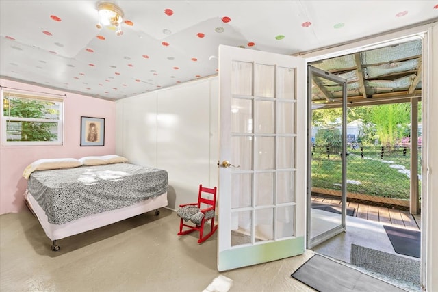 bedroom featuring vaulted ceiling, access to exterior, and concrete floors