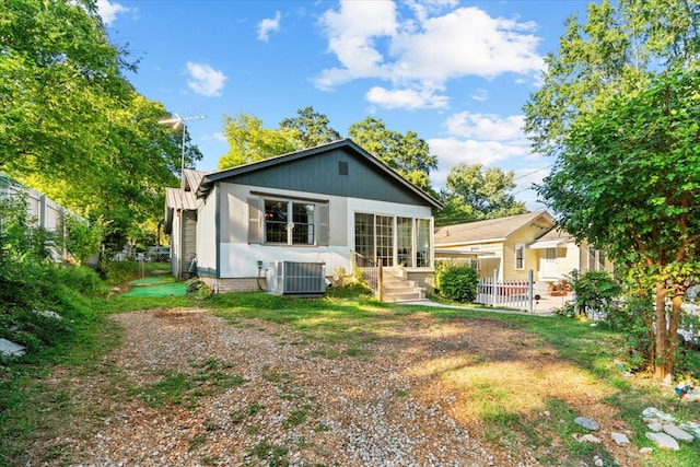 rear view of property featuring cooling unit