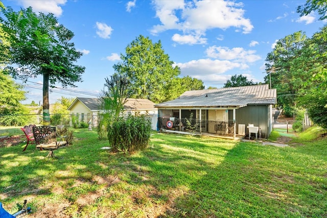 rear view of house featuring a lawn