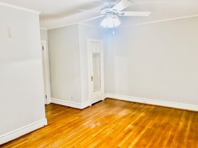 spare room with crown molding, wood-type flooring, and ceiling fan