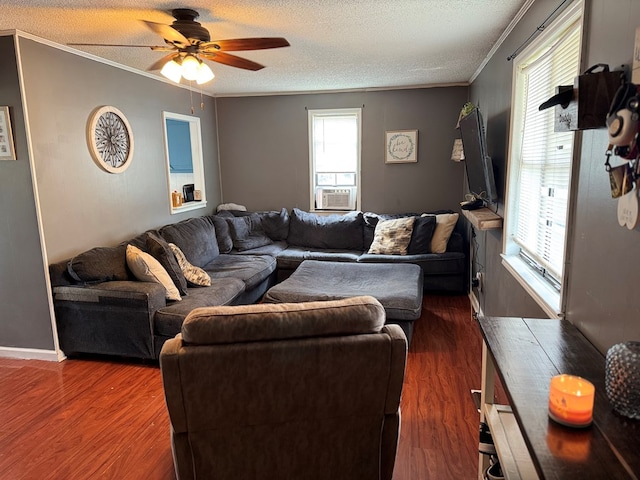 living area featuring dark wood-style flooring, crown molding, a textured ceiling, and ceiling fan