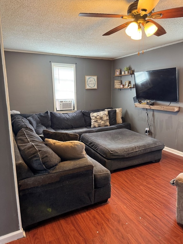 living room featuring a ceiling fan, a textured ceiling, wood finished floors, cooling unit, and baseboards