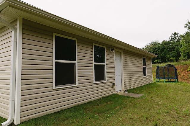 283 Parkland Way, Chatsworth, GA 30705 - view of home's exterior with a trampoline and a yard