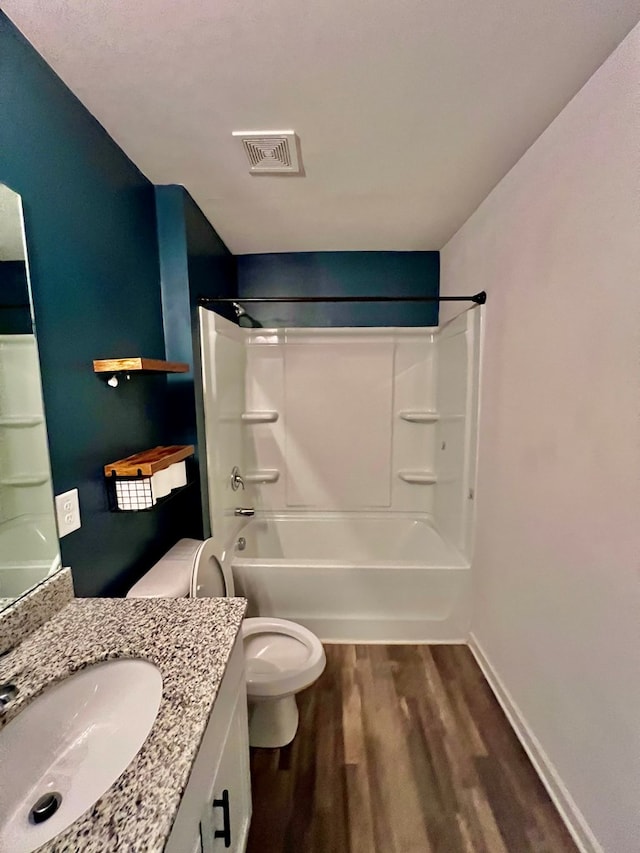 full bathroom with toilet, visible vents, vanity, bathtub / shower combination, and wood finished floors