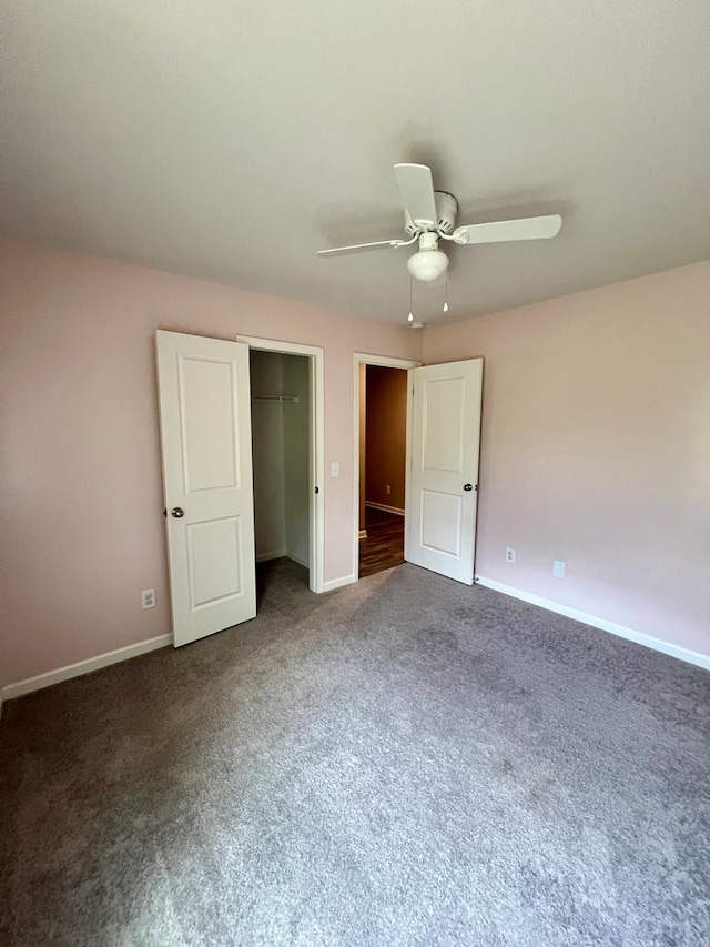 unfurnished bedroom featuring carpet flooring, a closet, baseboards, and a ceiling fan