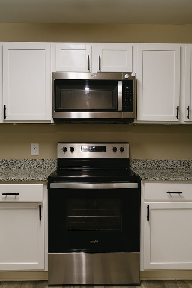 283 Parkland Way, Chatsworth, GA 30705 - kitchen featuring stainless steel appliances, white cabinetry, and light stone counters