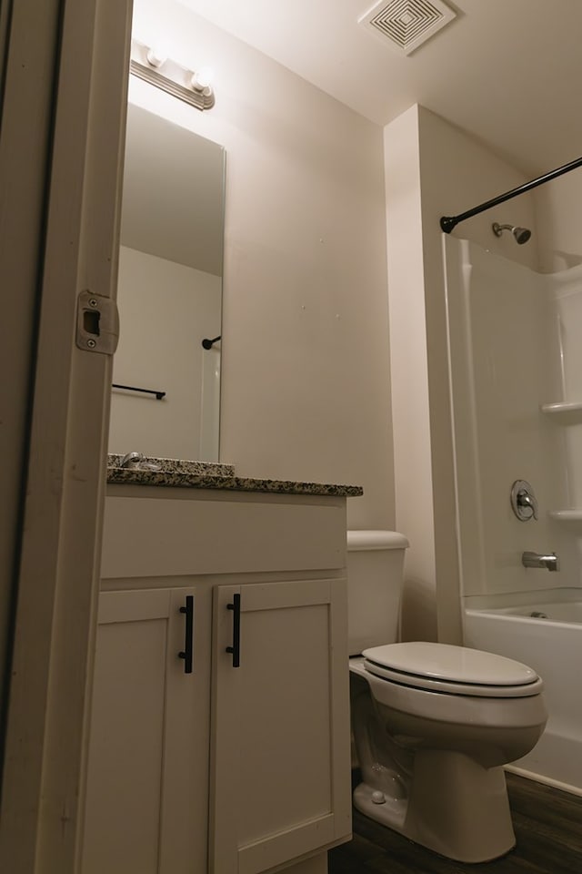 283 Parkland Way, Chatsworth, GA 30705 - bathroom with vanity, toilet, tub / shower combination, and wood finished floors