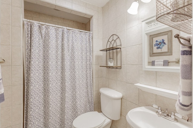 bathroom featuring sink, tile walls, and toilet