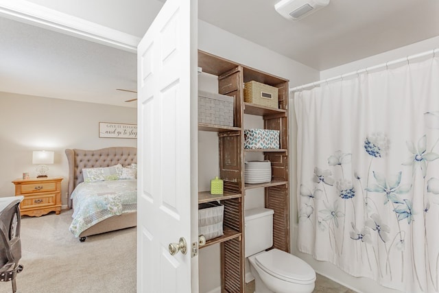 bathroom with shower / bathtub combination with curtain and toilet