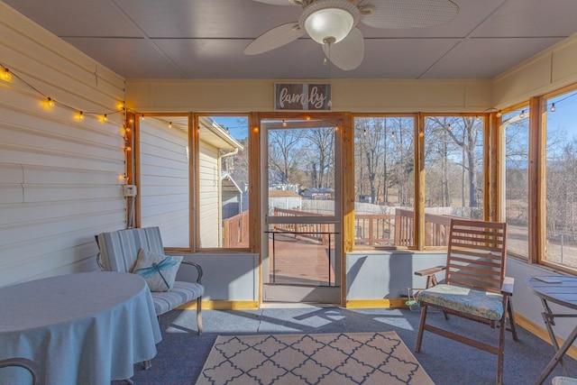 sunroom featuring ceiling fan