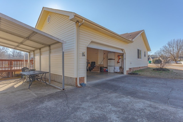 view of side of home featuring a carport and a garage