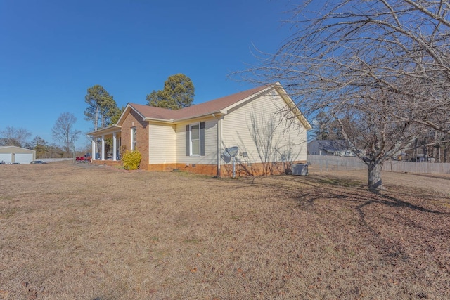 view of side of property with a lawn