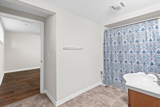 bathroom featuring vanity and a textured ceiling