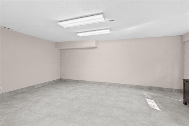 unfurnished room with a textured ceiling