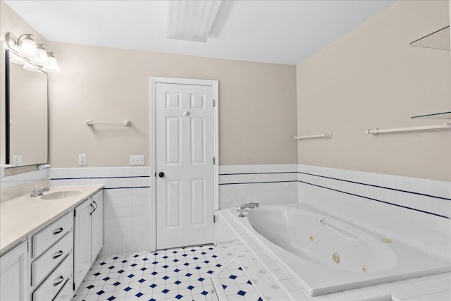 bathroom with vanity, tiled bath, and tile walls