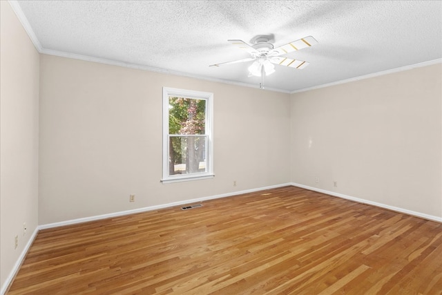 empty room with crown molding, ceiling fan, light hardwood / wood-style floors, and a textured ceiling