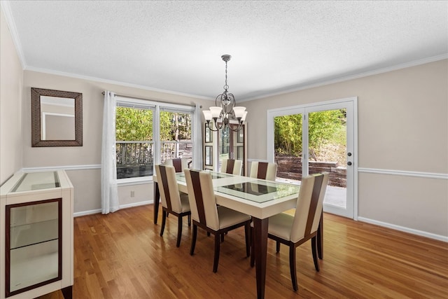 dining room featuring hardwood / wood-style flooring, a textured ceiling, and a chandelier