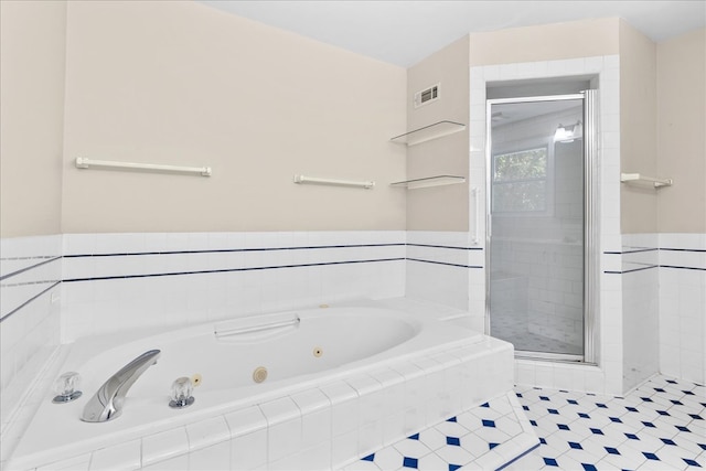 bathroom with shower with separate bathtub and tile patterned flooring