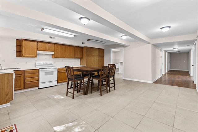 kitchen with light tile patterned floors and white electric range