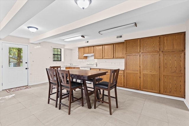 dining area with sink and light tile patterned flooring