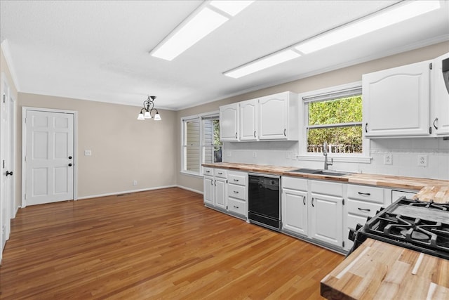 kitchen with white cabinetry, wood counters, dishwasher, and sink