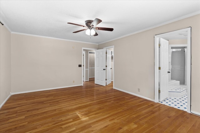 unfurnished bedroom with hardwood / wood-style flooring and crown molding