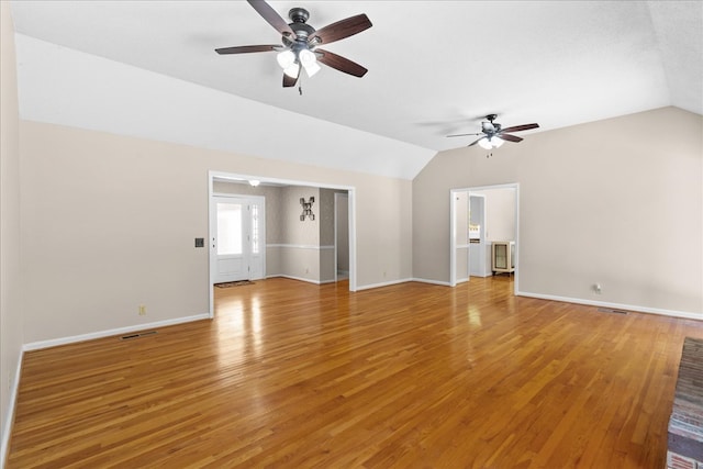 unfurnished living room with hardwood / wood-style flooring, ceiling fan, and vaulted ceiling