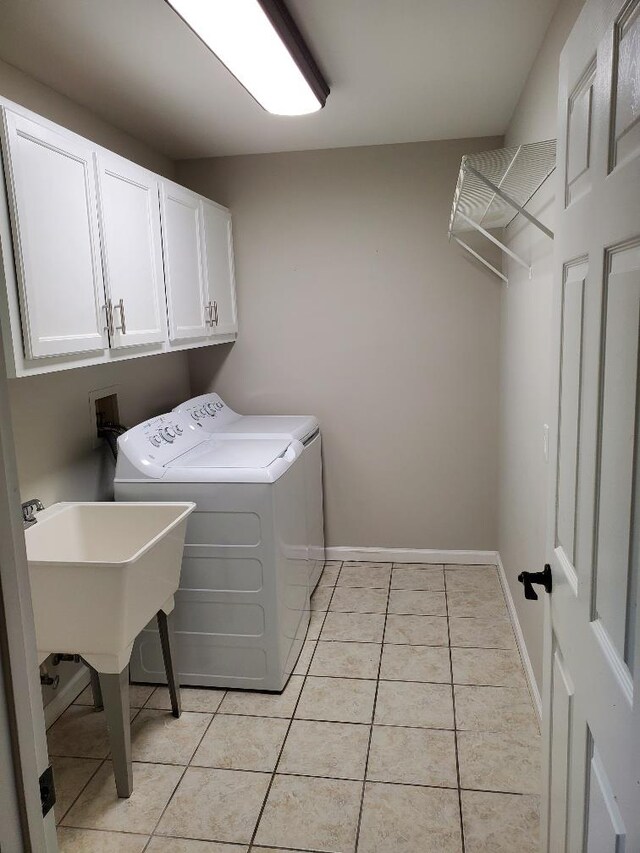 laundry room with cabinets, independent washer and dryer, and light tile patterned floors