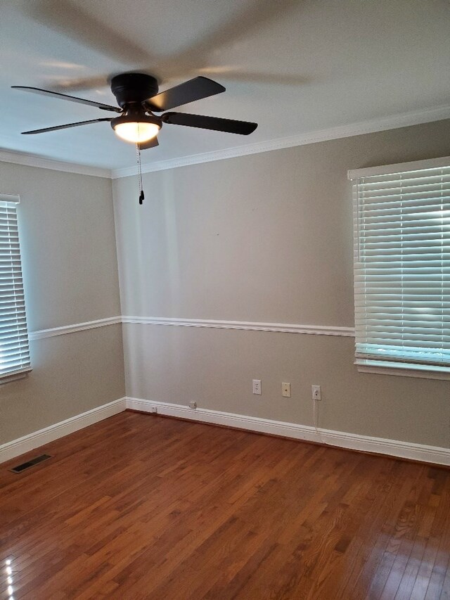 spare room featuring ceiling fan, ornamental molding, and wood-type flooring