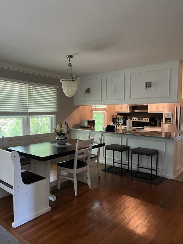 dining area with dark hardwood / wood-style flooring