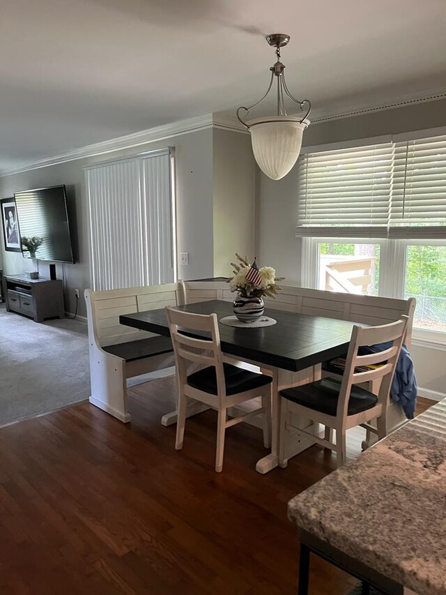 dining room with ornamental molding and dark hardwood / wood-style floors