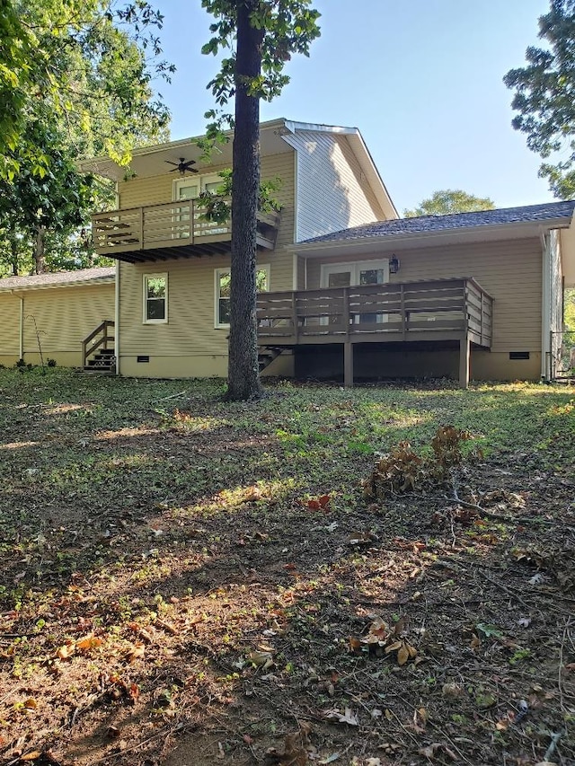 rear view of property featuring a wooden deck and a balcony