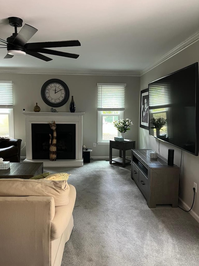 living room featuring crown molding, carpet, and ceiling fan