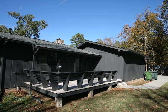 rear view of house featuring a wooden deck