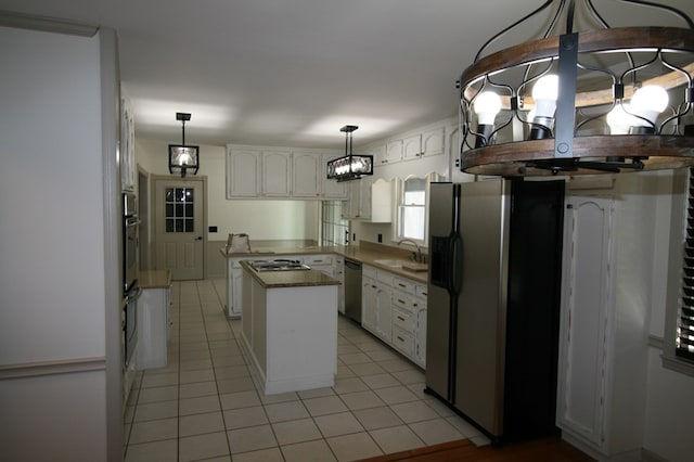 kitchen featuring pendant lighting, a center island, white cabinets, and appliances with stainless steel finishes