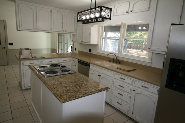 kitchen featuring a kitchen island, pendant lighting, white cabinetry, sink, and stainless steel appliances