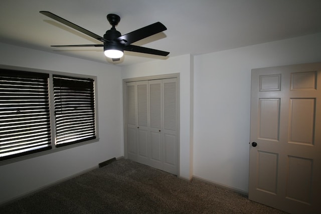 unfurnished bedroom featuring carpet flooring, ceiling fan, and a closet