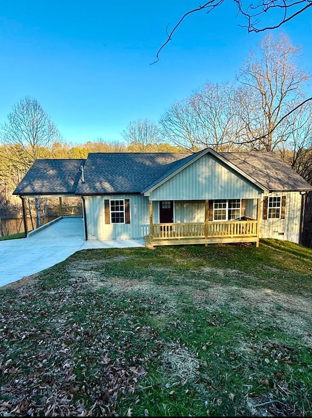 single story home with a porch, a carport, and a front lawn