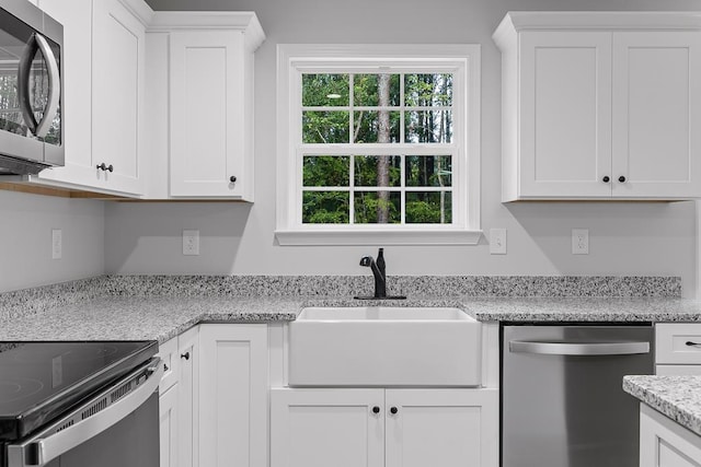 kitchen with sink, white cabinets, and appliances with stainless steel finishes