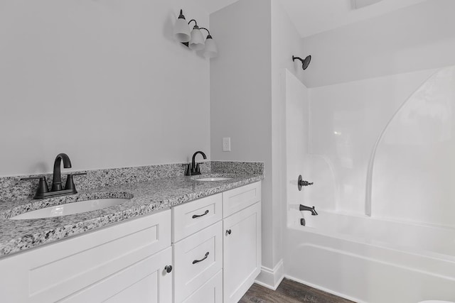 bathroom featuring vanity, hardwood / wood-style floors, and shower / bathing tub combination