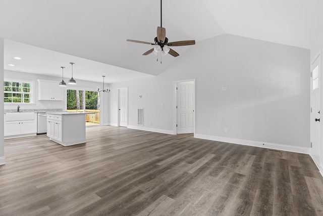 unfurnished living room with wood-type flooring, sink, ceiling fan with notable chandelier, and high vaulted ceiling