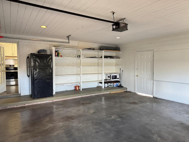 garage with black refrigerator, a garage door opener, and wooden ceiling