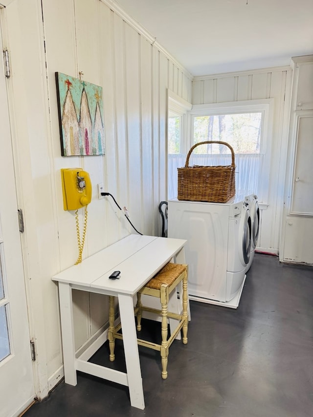 clothes washing area with washer and clothes dryer