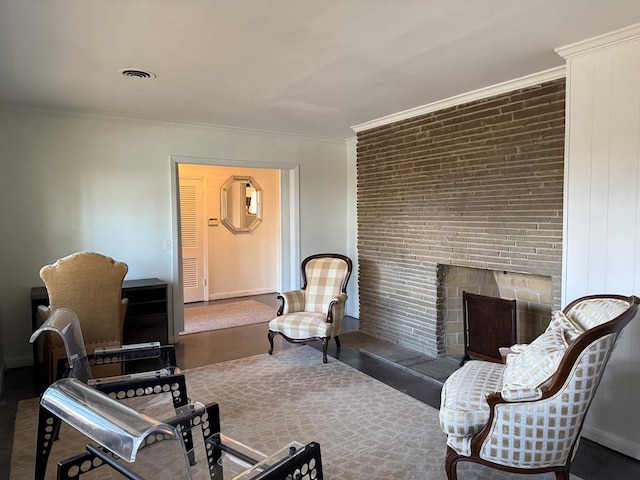 living room featuring ornamental molding and a brick fireplace