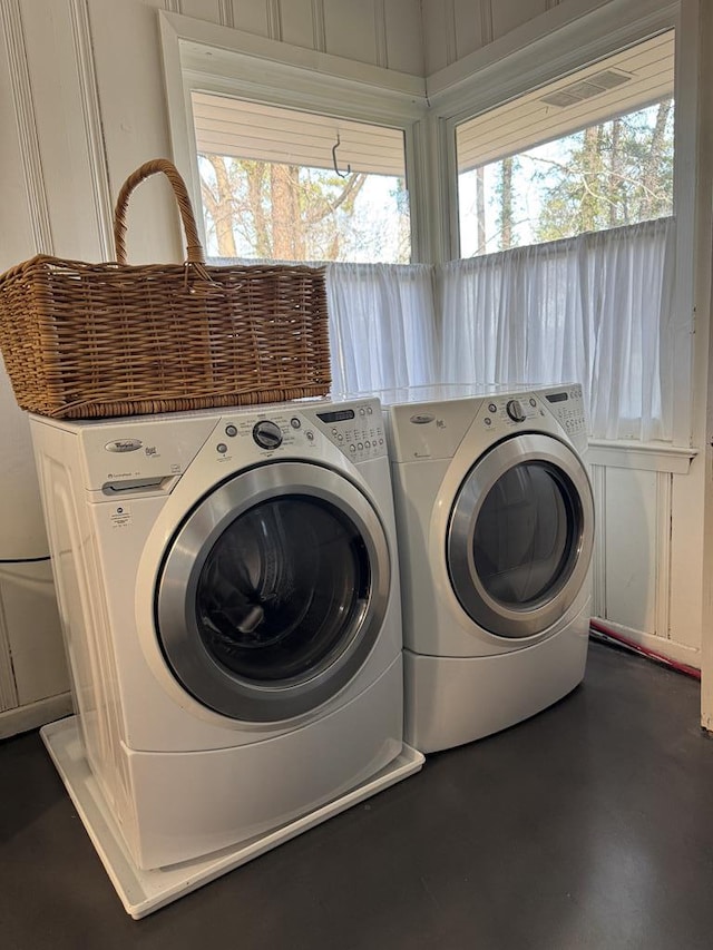 clothes washing area with washing machine and clothes dryer