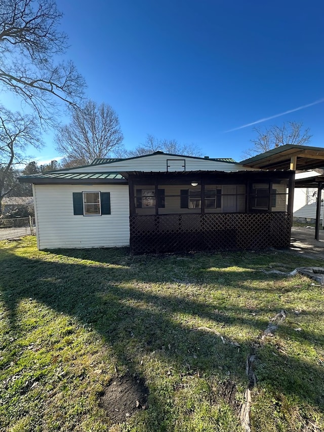 back of house with a lawn