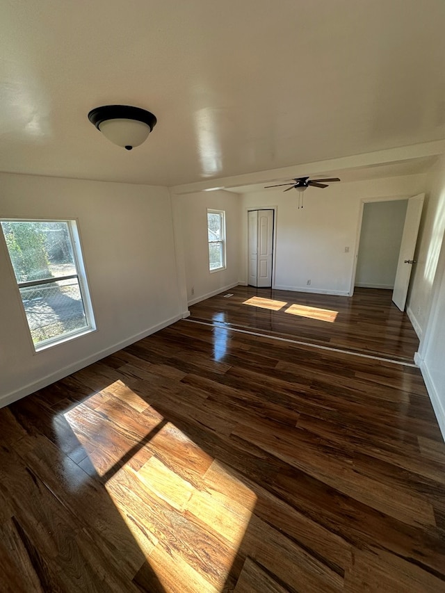 spare room featuring dark wood-type flooring and ceiling fan